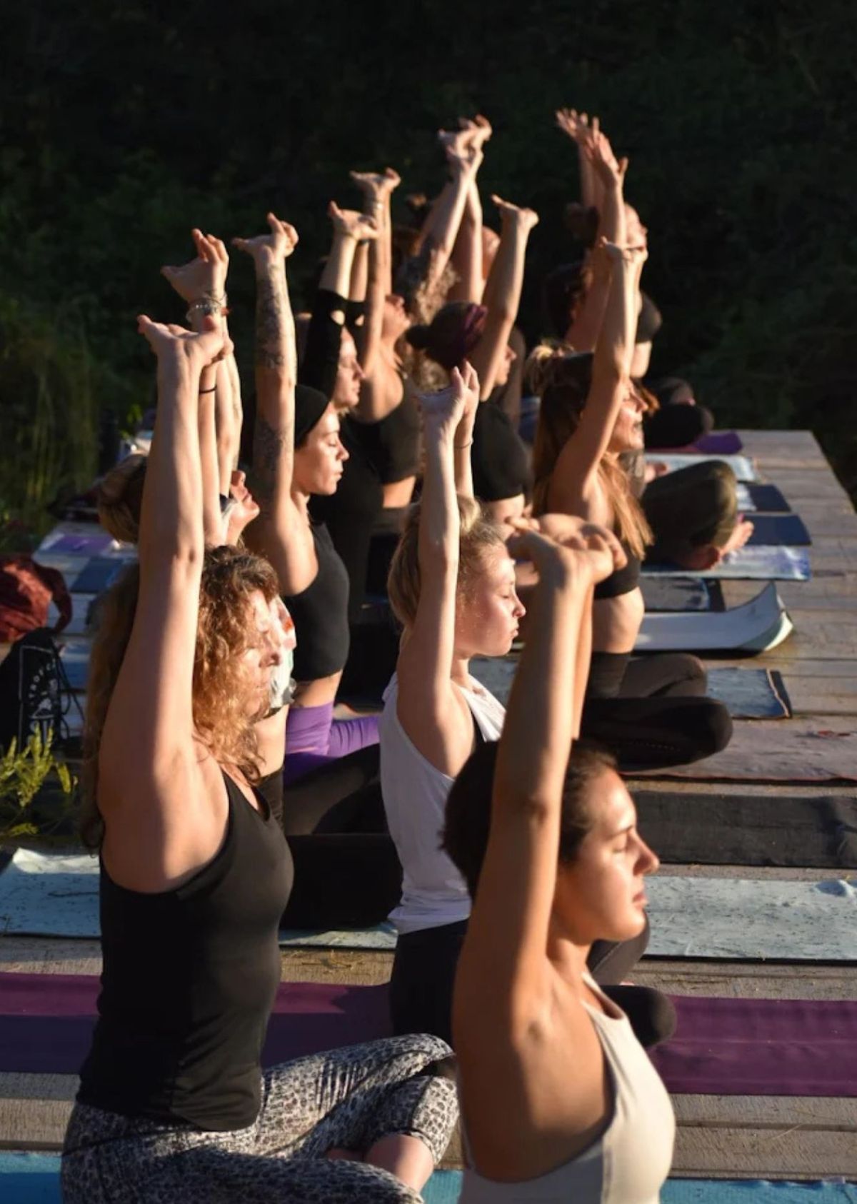 Yoga students on the open-air deck at The Sanctuary at Two Rivers retreat center Costa Rica